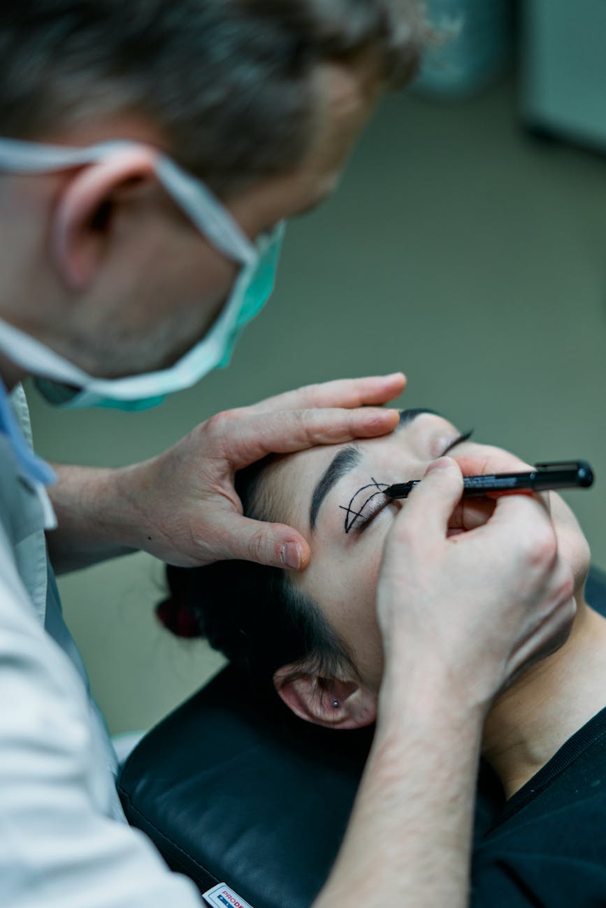 surgeon marking a patient s eyelid