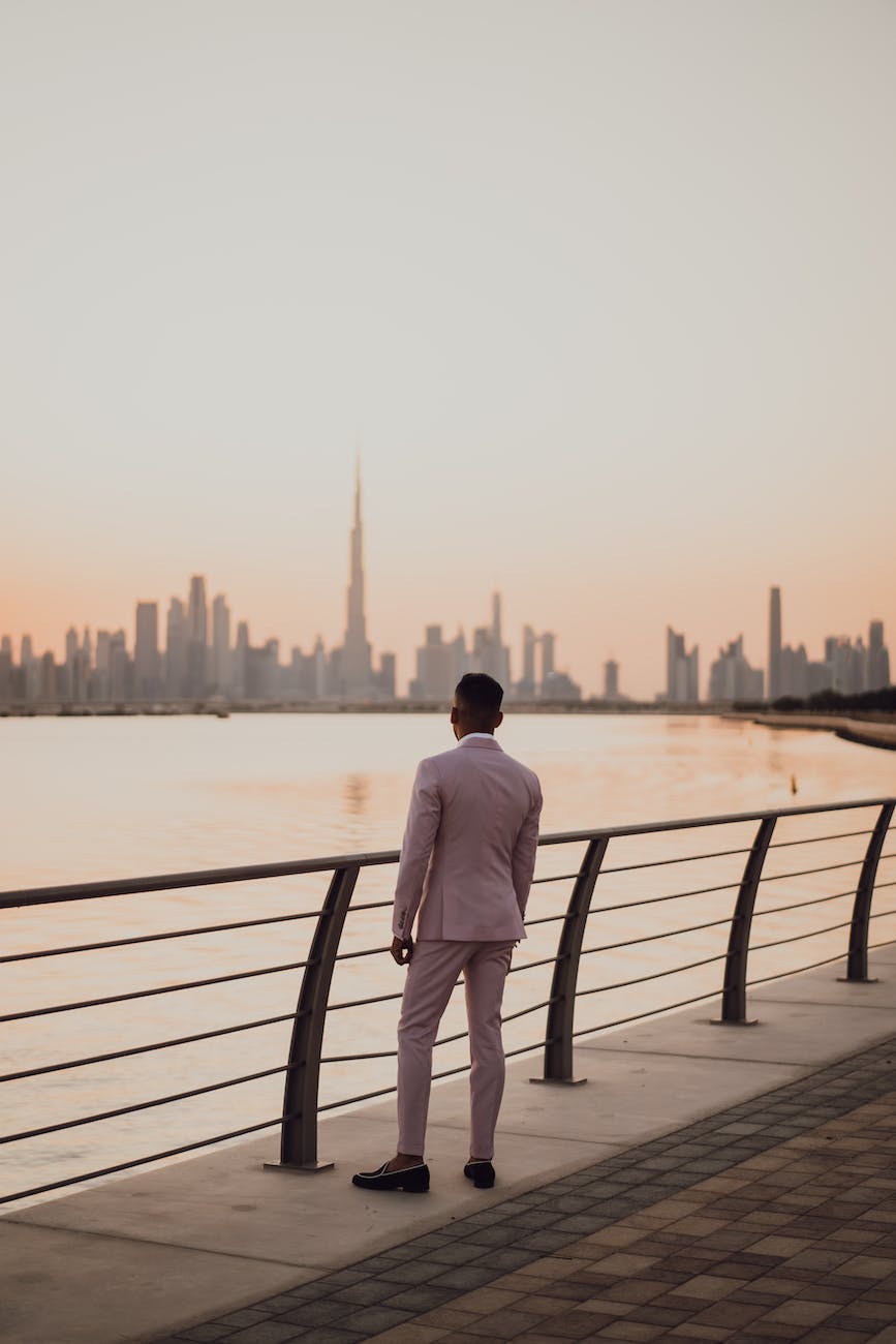 photo of man standing near handrails